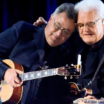 Ricky Skaggs Joins Vince Gill For Emotional “Go Rest High” Performance On “Opry 100”