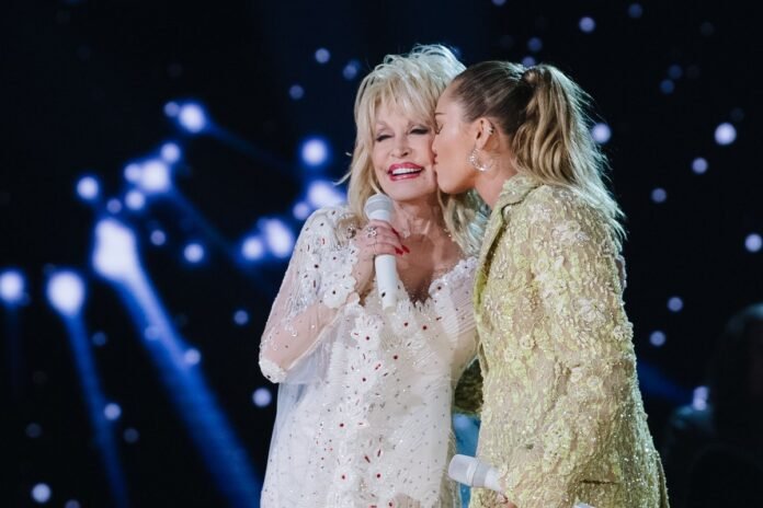 Dolly Parton comforts Miley Cyrus after her emotional onstage moment.