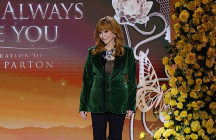 Reba McEntire pays tribute to Dolly Parton at concert event.